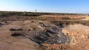 aerial view of landfill with large equipment working